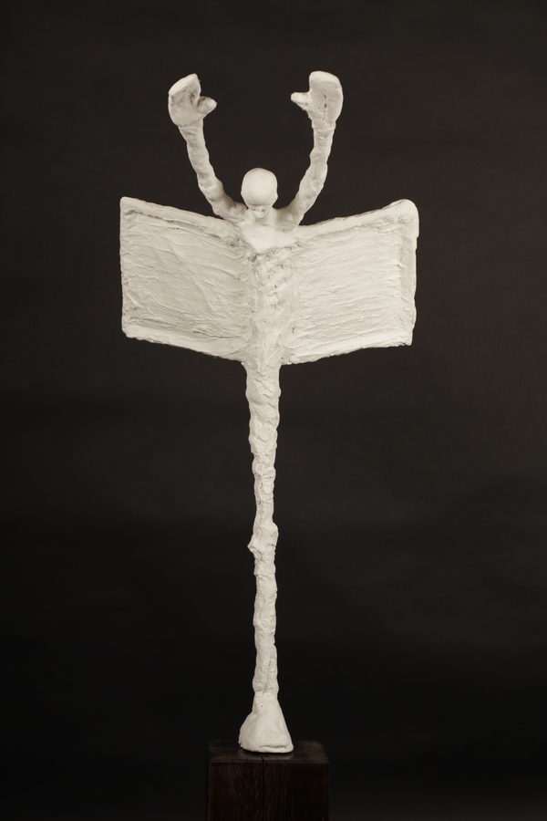 The Scribe (2023) by Valeriu Cazacevschi. A pale standing figure with raised arms and a broad, open book-like form.