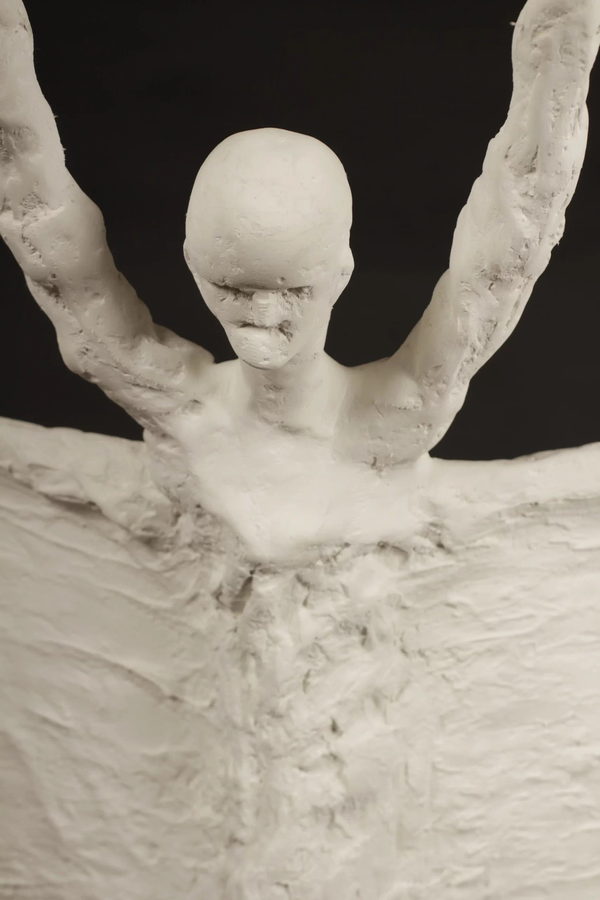 The Scribe by Valeriu Cazacevschi. Detail of the face, raised arms and textured open book.