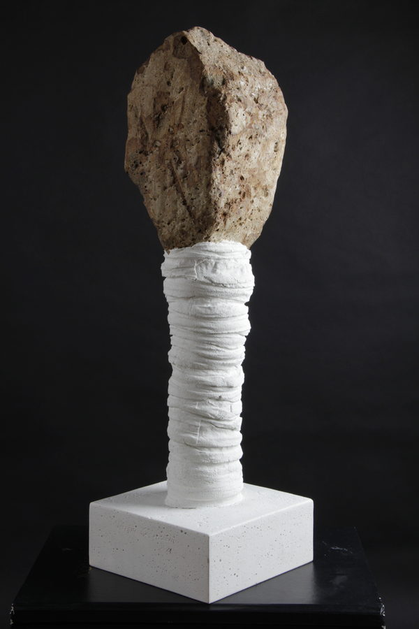 Stone of Memory (2021) by Valeriu Cazacevschi. A rough, pale head above a wrapped white column on a square base.